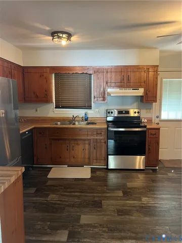 a kitchen with stainless steel appliances wooden cabinets and a counter top space