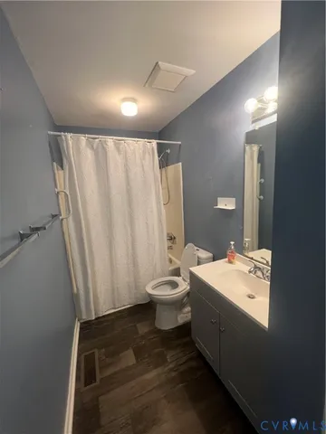 a bathroom with a double vanity sink toilet and a mirror