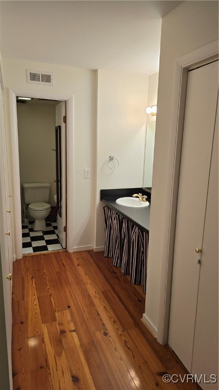10312 Iron Mill Road Richmond, VA 23235 - Photo 20 of 22 Bathroom featuring wood-type flooring, toilet, and