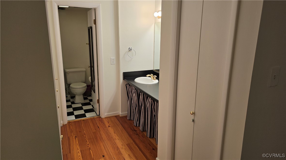10312 Iron Mill Road Richmond, VA 23235 - Photo 21 of 22 Bathroom featuring vanity, toilet, and wood-type f