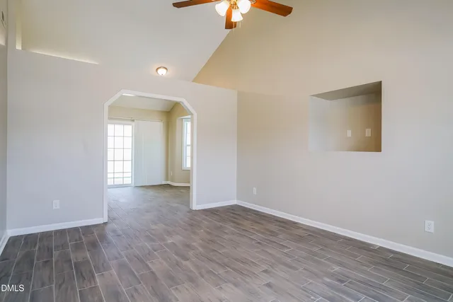 wooden floor in an empty room with a window