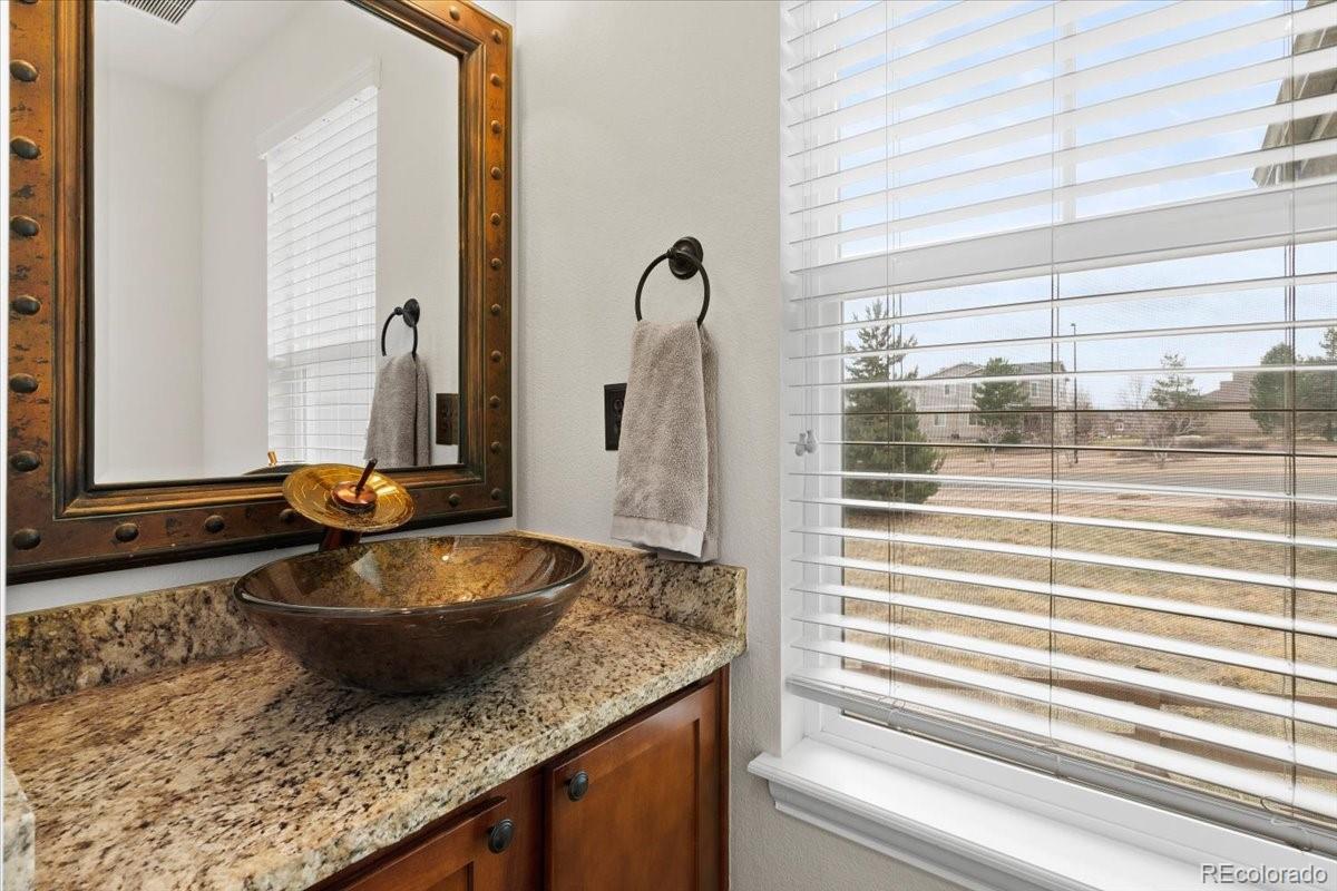 1906 Charbray Point Castle Rock, CO 80108 - Photo 16 of 44 a bathroom with a granite countertop sink and a mirror