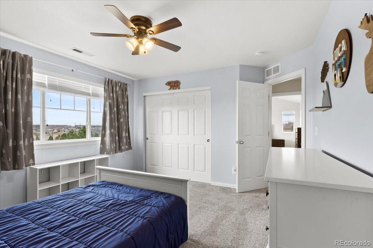 1906 Charbray Point Castle Rock, CO 80108 - Photo 23 of 44 a bedroom with a bed and a large window