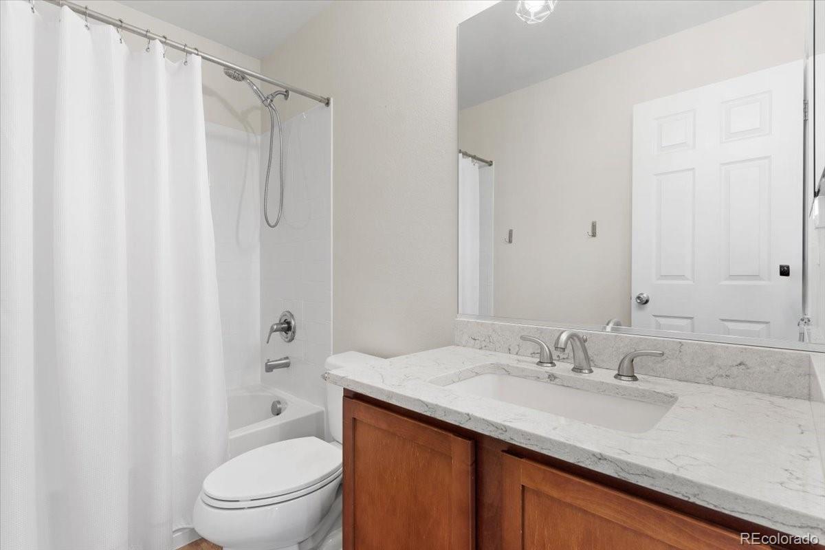1906 Charbray Point Castle Rock, CO 80108 - Photo 24 of 44 a bathroom with a granite countertop sink toilet and shower