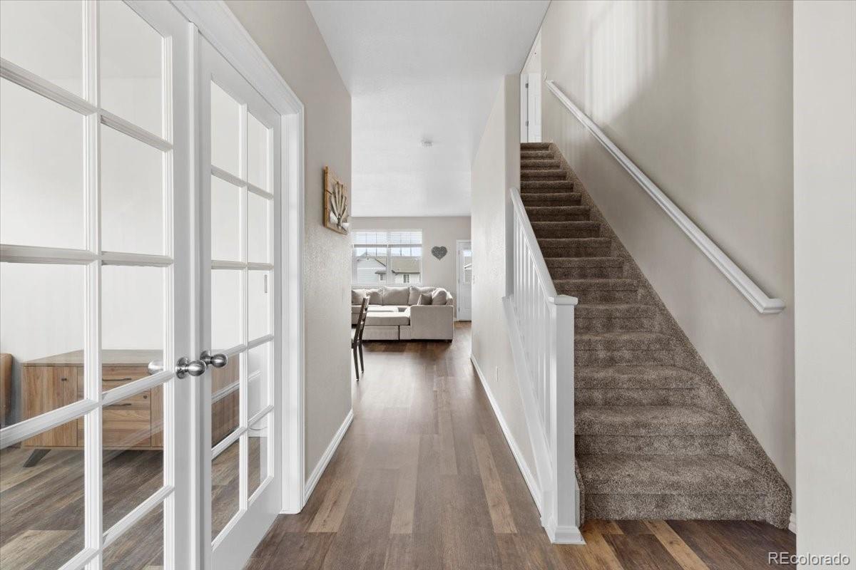 1906 Charbray Point Castle Rock, CO 80108 - Photo 4 of 44 a view of a hallway with wooden floor and staircase