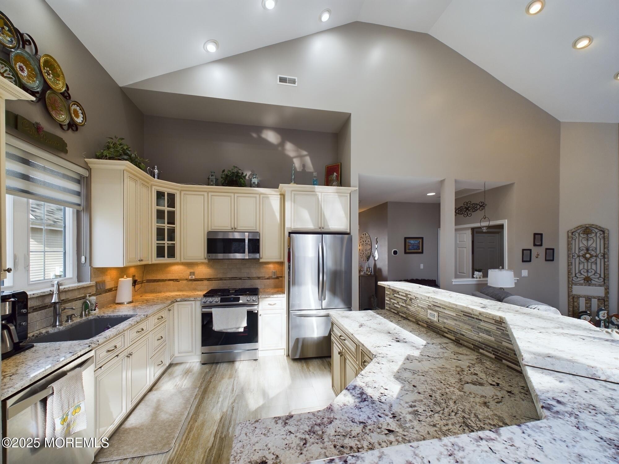 89 Pebble Beach Boulevard Jackson, NJ 08527 - Photo 11 of 42 a large kitchen with stainless steel appliances kitchen island granite countertop a stove and cabinets