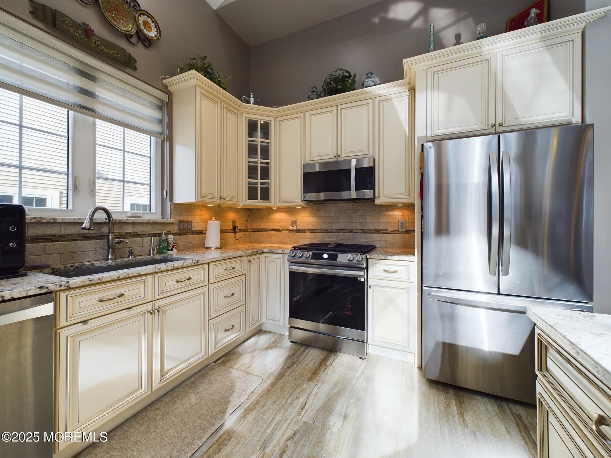89 Pebble Beach Boulevard Jackson, NJ 08527 - Photo 12 of 42 a kitchen with stainless steel appliances a refrigerator sink and microwave