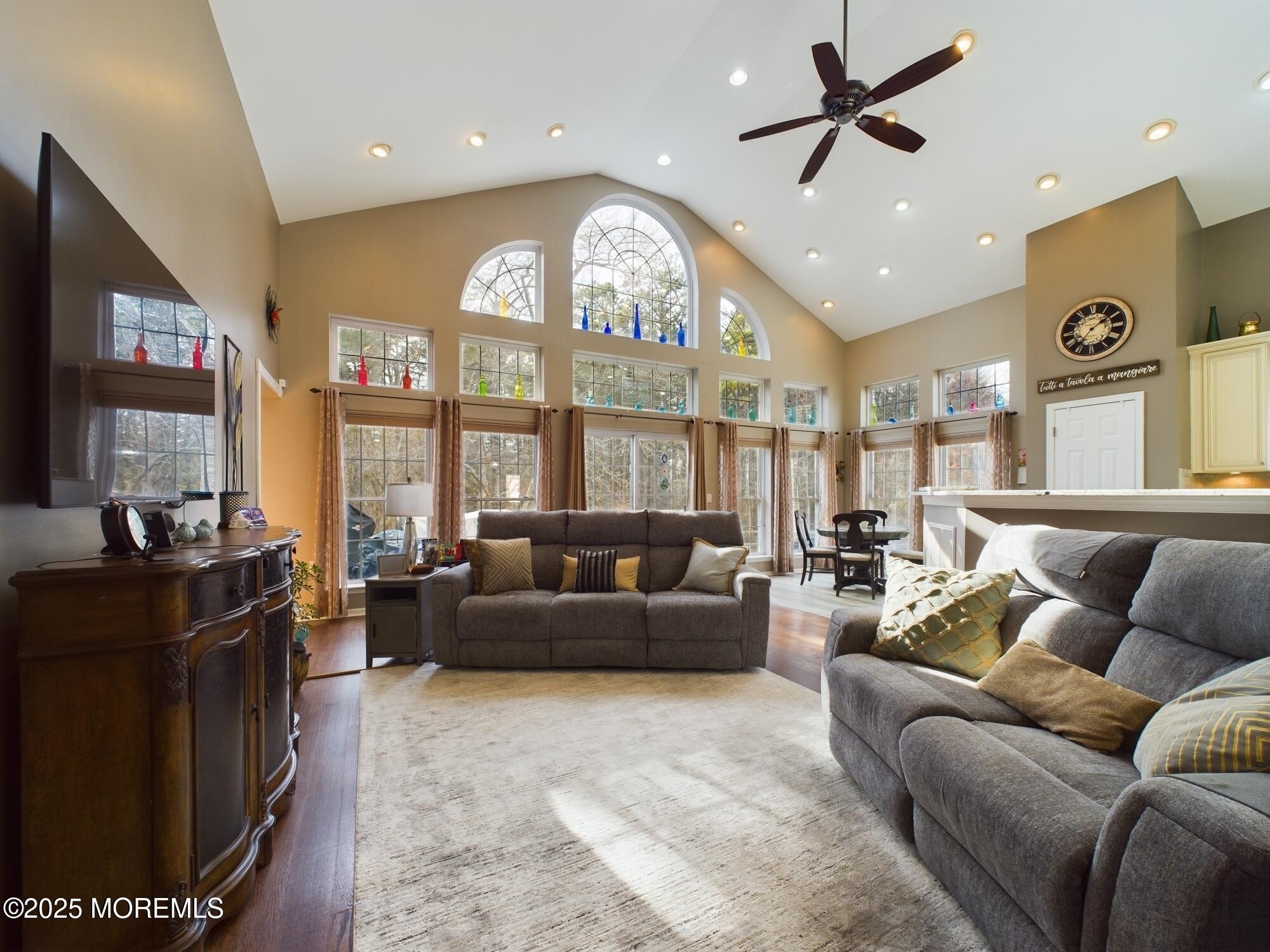 89 Pebble Beach Boulevard Jackson, NJ 08527 - Photo 16 of 42 a living room with furniture a large window and a clock