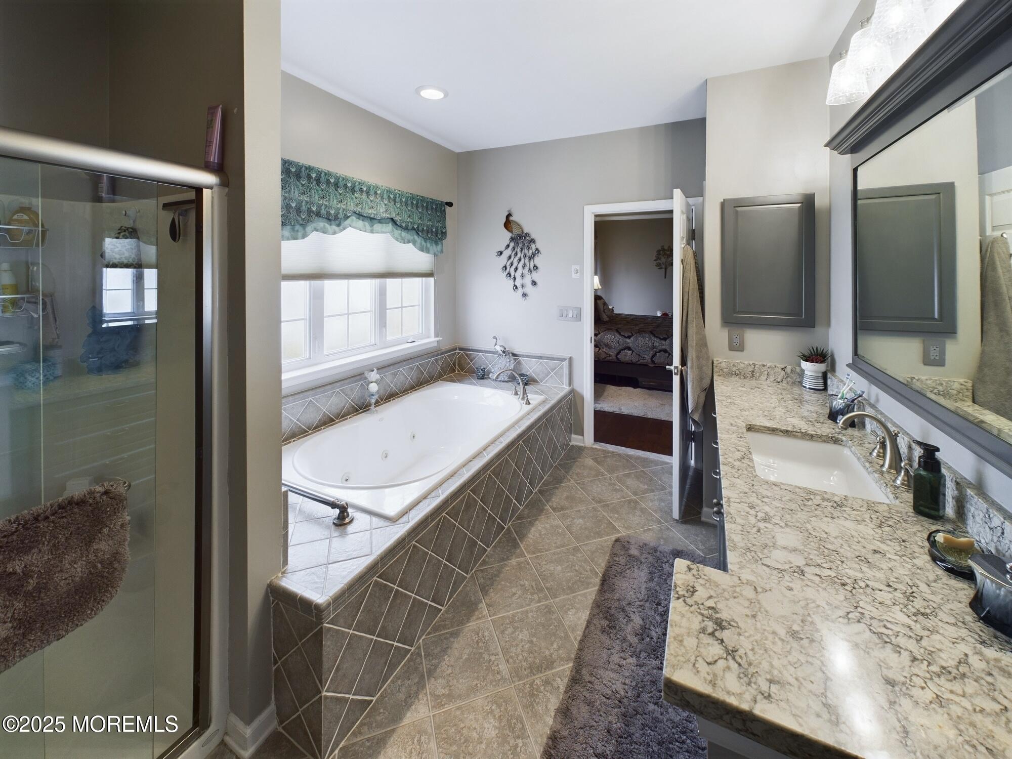 89 Pebble Beach Boulevard Jackson, NJ 08527 - Photo 27 of 42 a bathroom with a granite countertop sink a mirror and shower