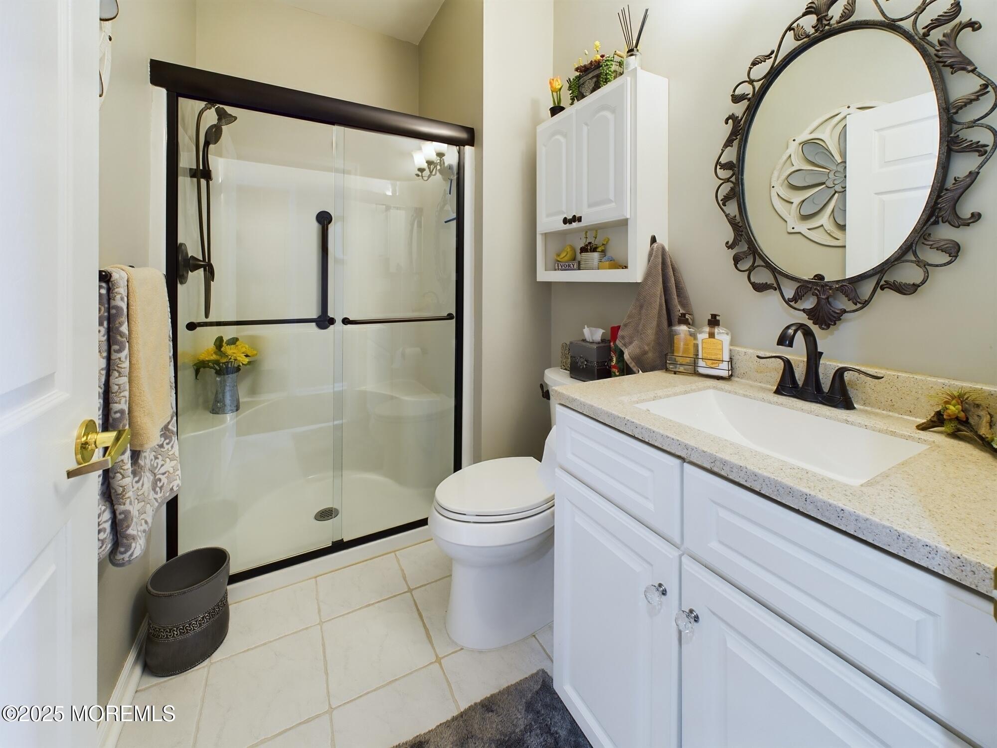 89 Pebble Beach Boulevard Jackson, NJ 08527 - Photo 30 of 42 a bathroom with a sink a toilet and a mirror
