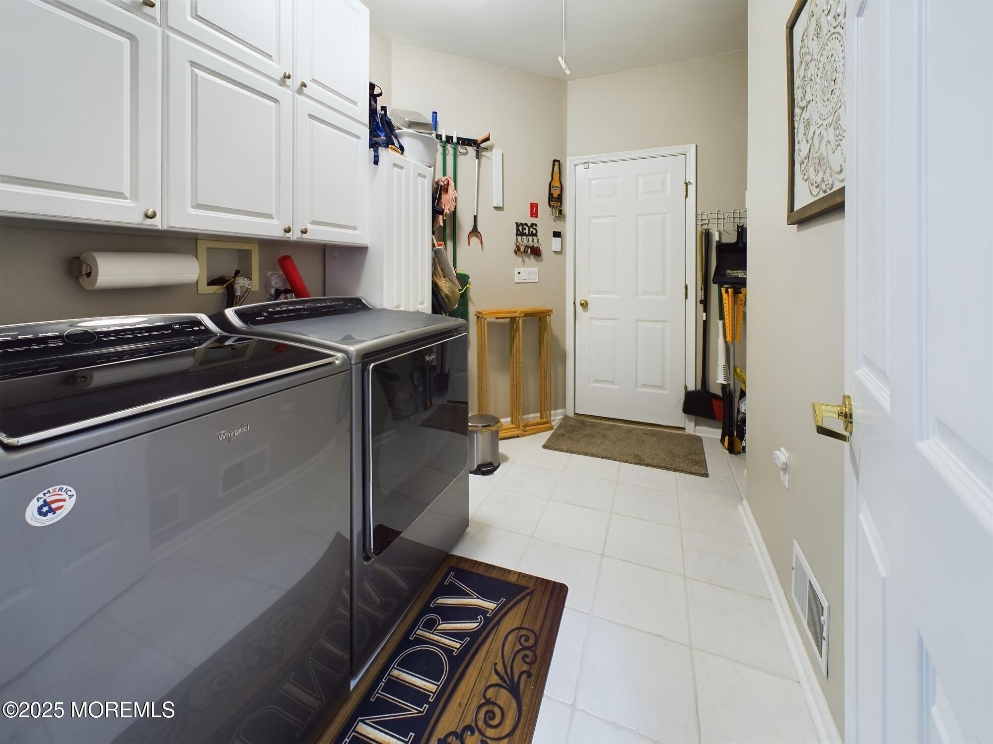 89 Pebble Beach Boulevard Jackson, NJ 08527 - Photo 32 of 42 a kitchen with a refrigerator and white cabinets