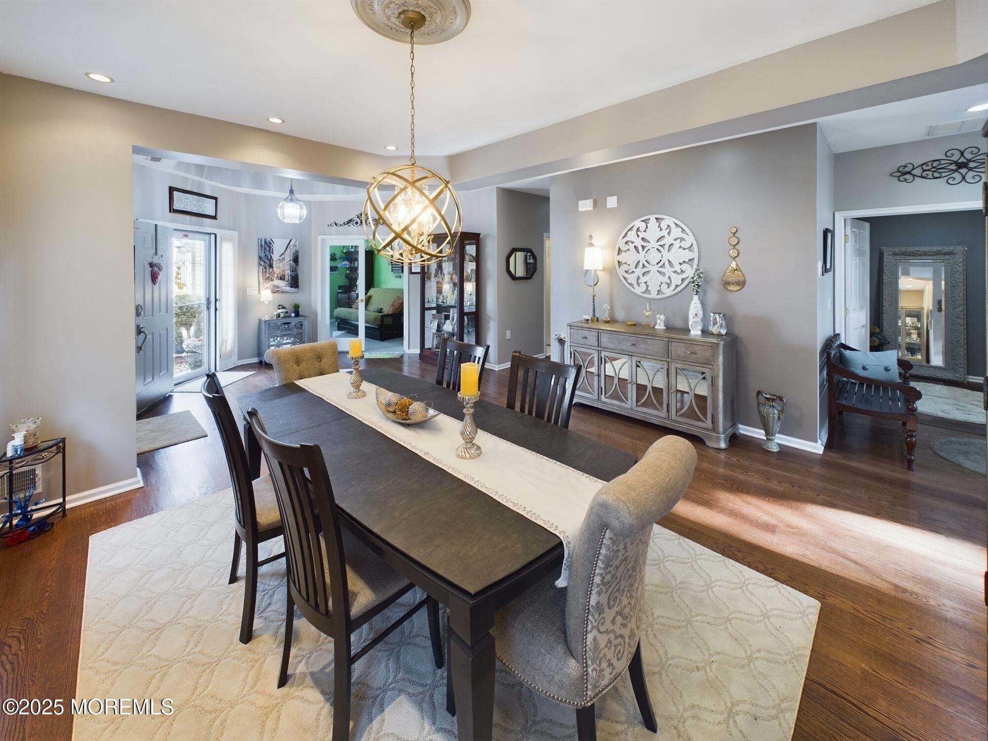 89 Pebble Beach Boulevard Jackson, NJ 08527 - Photo 8 of 42 a view of a dining room and livingroom with furniture wooden floor a chandelier