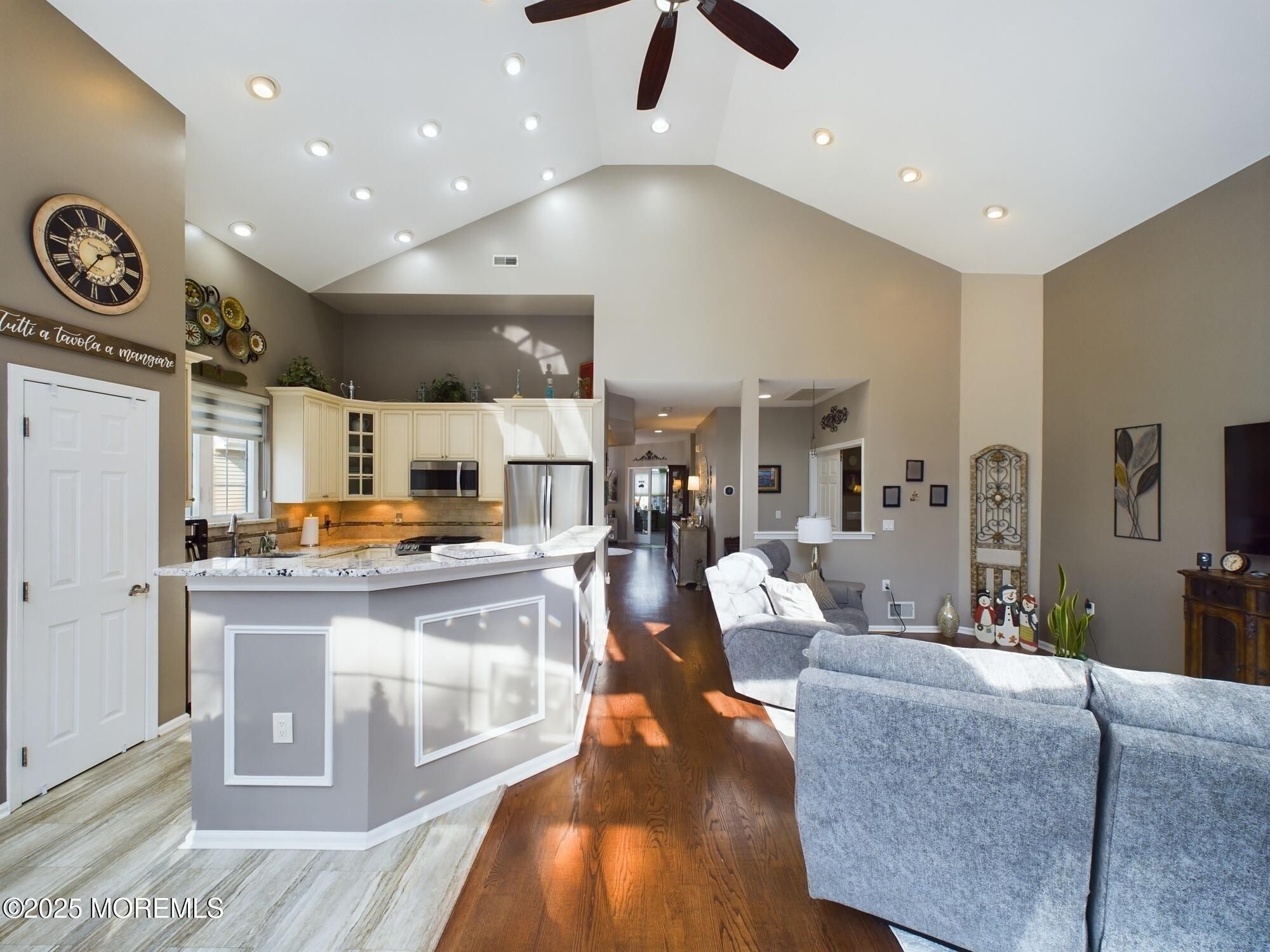 89 Pebble Beach Boulevard Jackson, NJ 08527 - Photo 9 of 42 a living room with stainless steel appliances furniture a clock and a view of kitchen