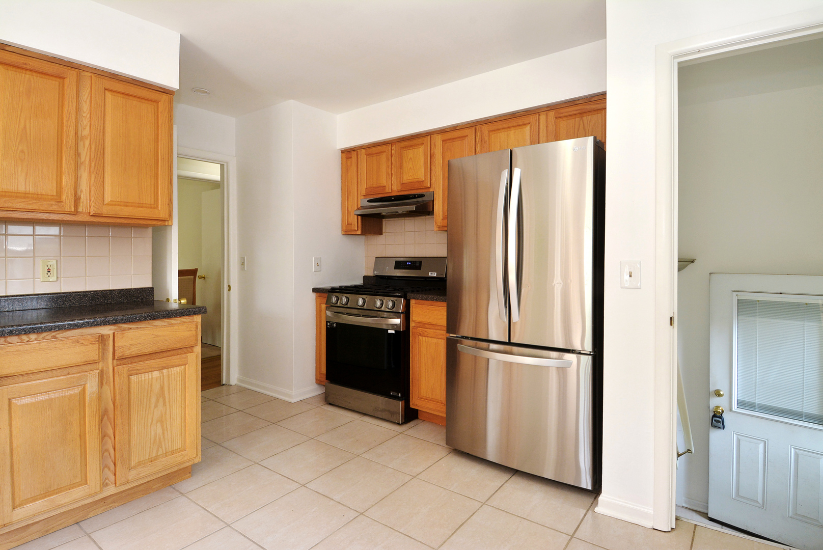 604 South Elmhurst Road South Mount Prospect, IL 60056 - Photo 13 of 18 a kitchen with stainless steel appliances granite countertop a refrigerator and a stove top oven