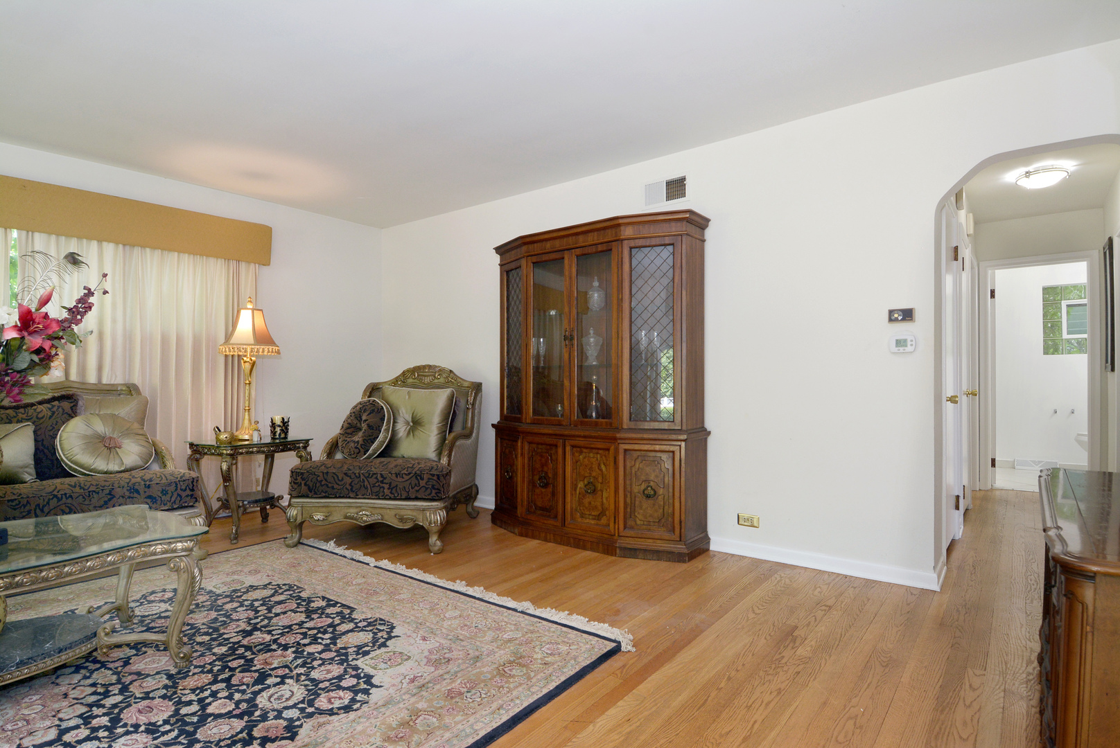 604 South Elmhurst Road South Mount Prospect, IL 60056 - Photo 4 of 18 a living room with furniture rug and a table