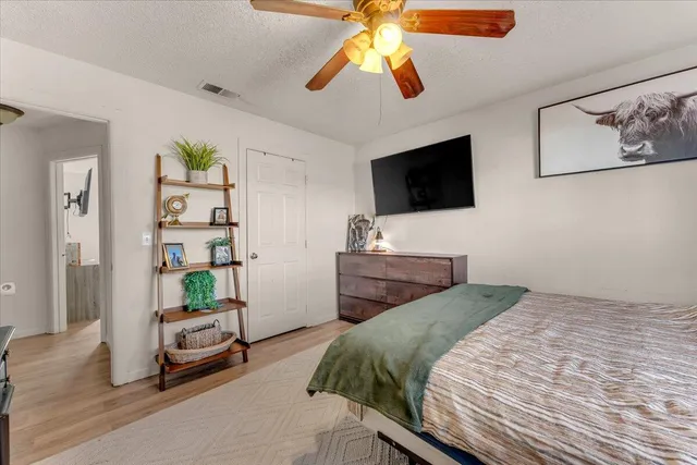 a bedroom with a bed and a flat screen tv
