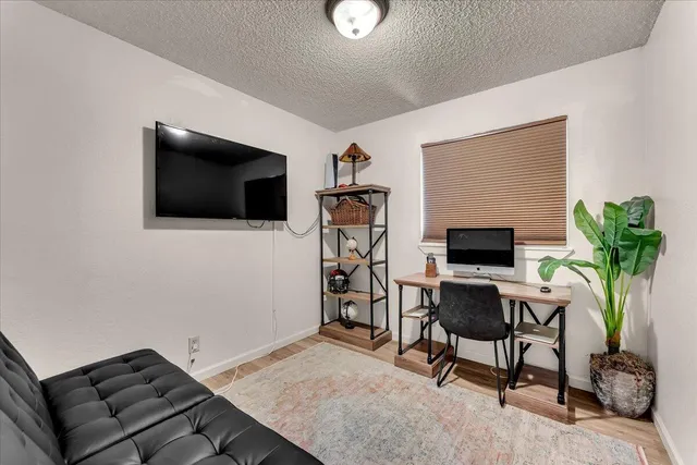a view of a livingroom with furniture and a flat screen tv