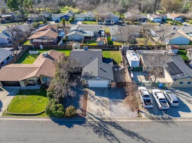 an aerial view of a house with a swimming pool yard and lake view