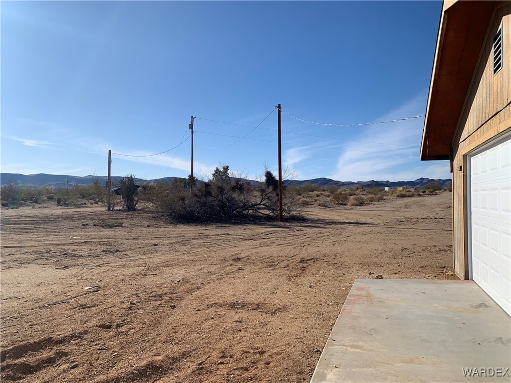 5118 Cordes Road Golden Valley, AZ 86413 - Photo 14 of 17 View of yard with a mountain view and a garage