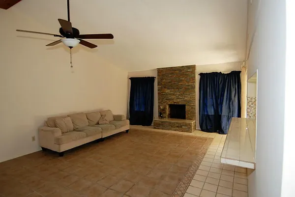 a view of room with hardwood floor and ceiling fan