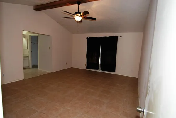 a view of a livingroom with kitchen and furniture