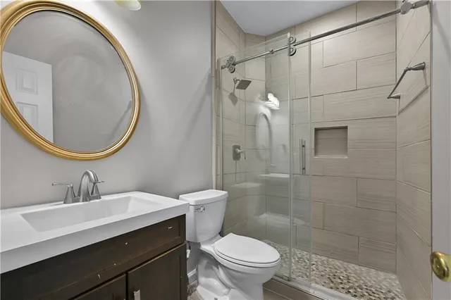 a view of a hallway with wooden floor and windows
