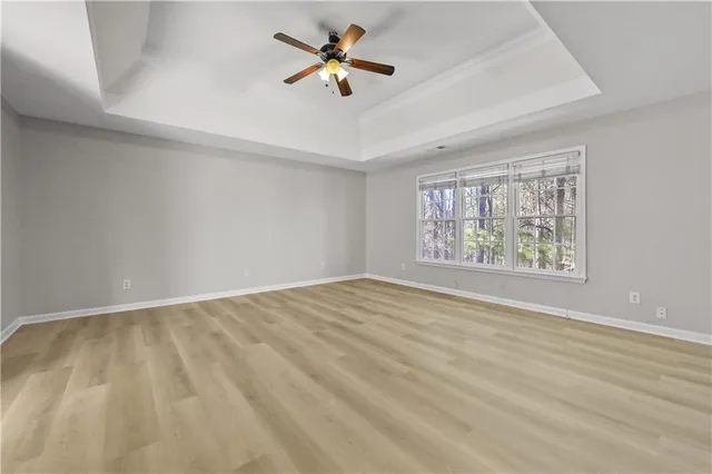 an empty room with fan and a ceiling fan