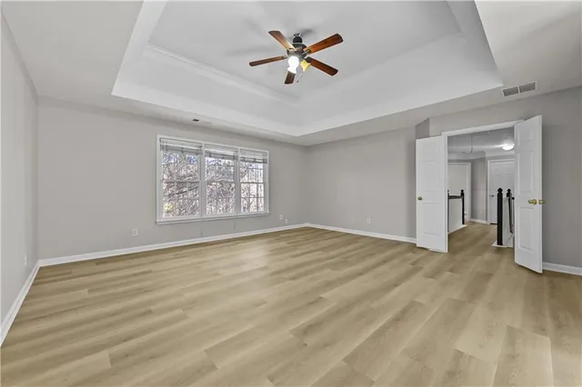 a view of an empty room with a ceiling fan