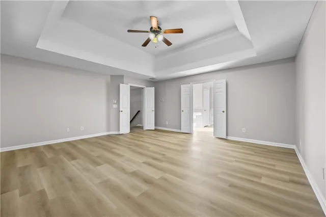 a spacious bathroom with a shower a sink and a mirror