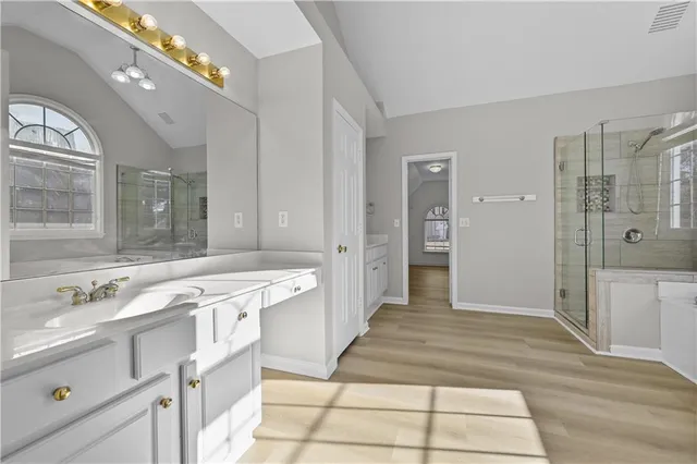 a spacious bathroom with a tub shower and sink
