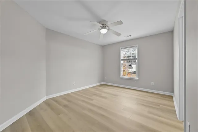 a view of an empty room with a ceiling fan