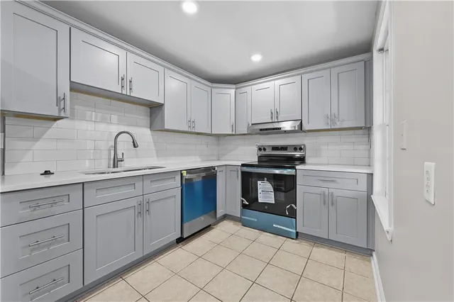 a view of an empty room with window and closet area