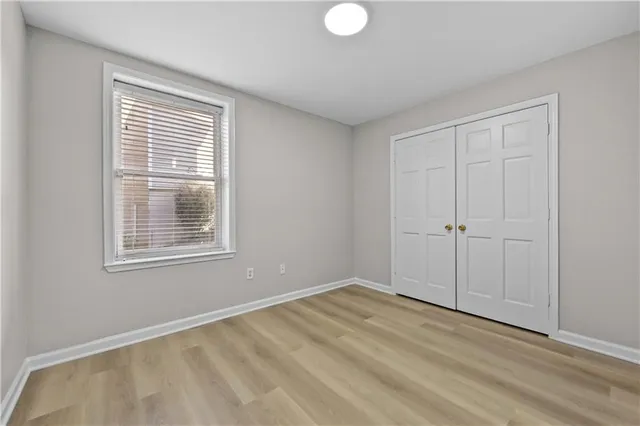 a balcony with wooden floor and fence