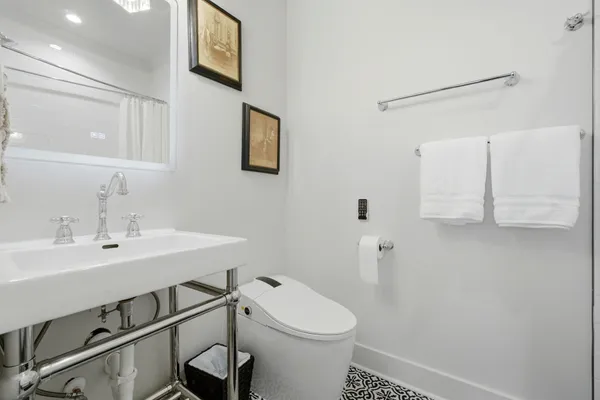a bathroom with a sink mirror toilet and bathtub
