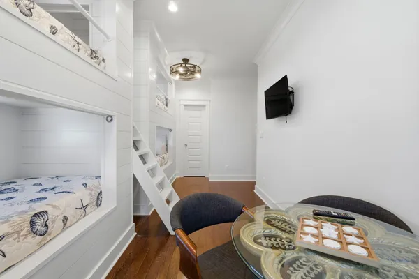 a spacious bedroom with a bed and a chandelier