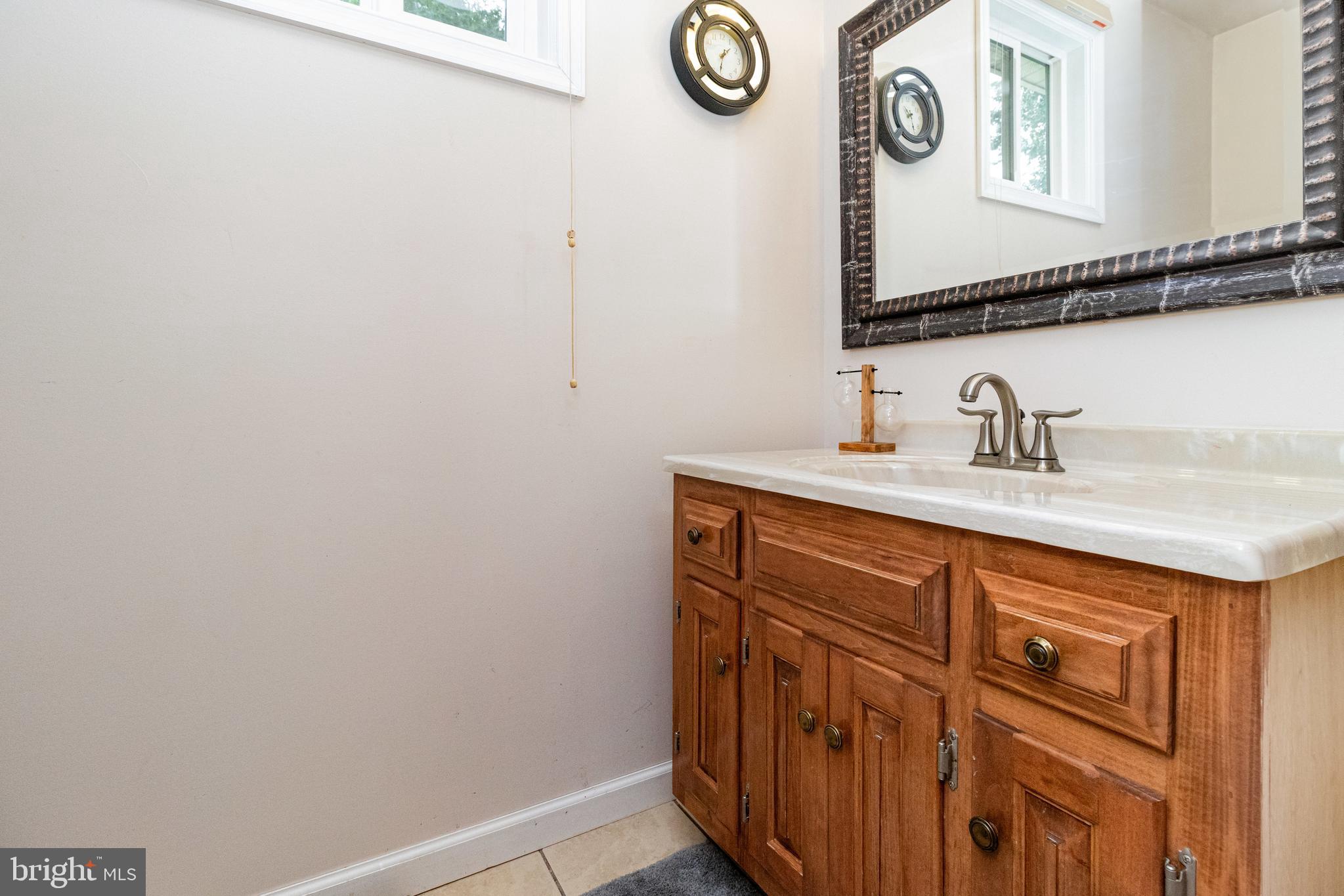 5212 Farmcrest Circle Prince George, VA 23875 - Photo 16 of 27 a bathroom with a sink and a mirror