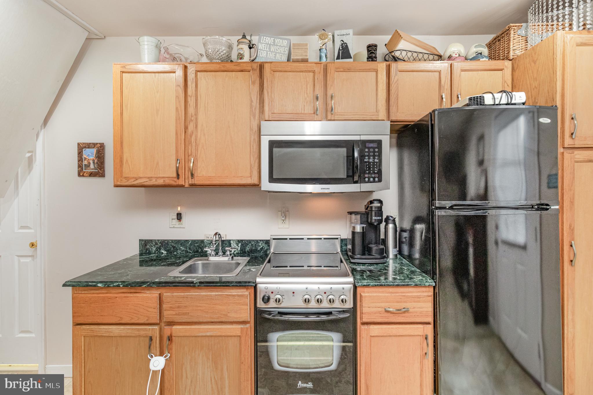 5212 Farmcrest Circle Prince George, VA 23875 - Photo 19 of 27 a kitchen with stainless steel appliances granite countertop a refrigerator stove and microwave