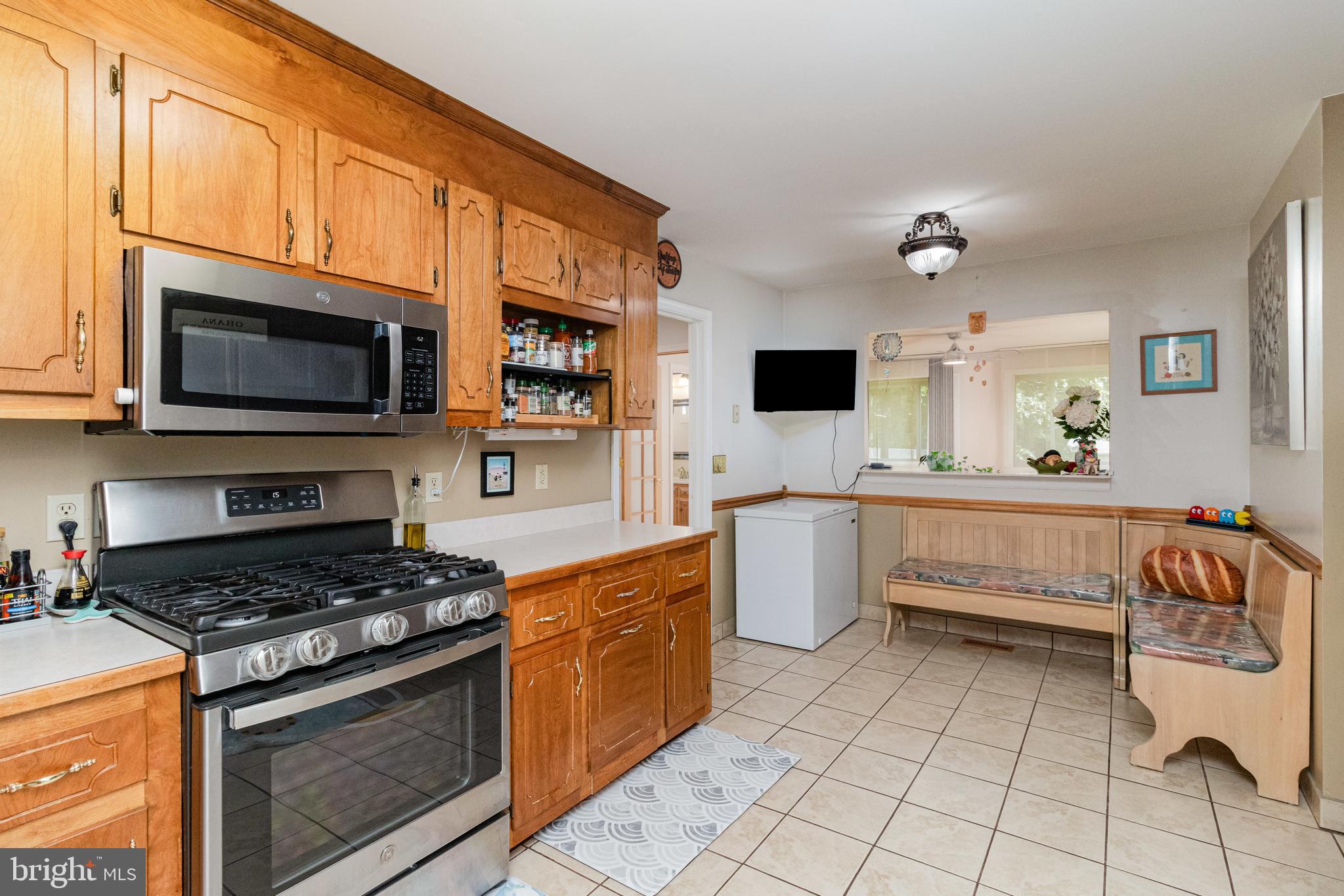 5212 Farmcrest Circle Prince George, VA 23875 - Photo 20 of 27 a kitchen with stainless steel appliances a stove sink microwave and cabinets