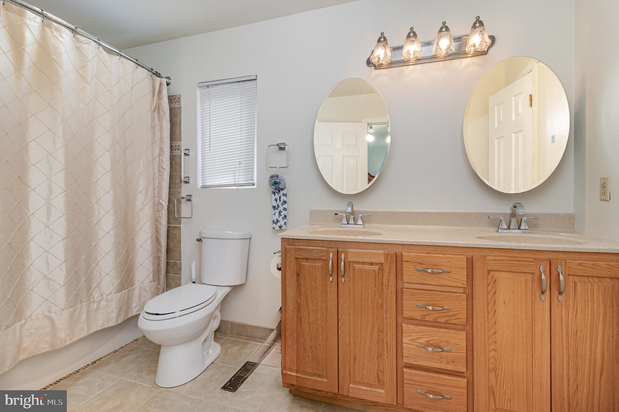 5212 Farmcrest Circle Prince George, VA 23875 - Photo 22 of 27 a bathroom with a toilet a sink and a mirror