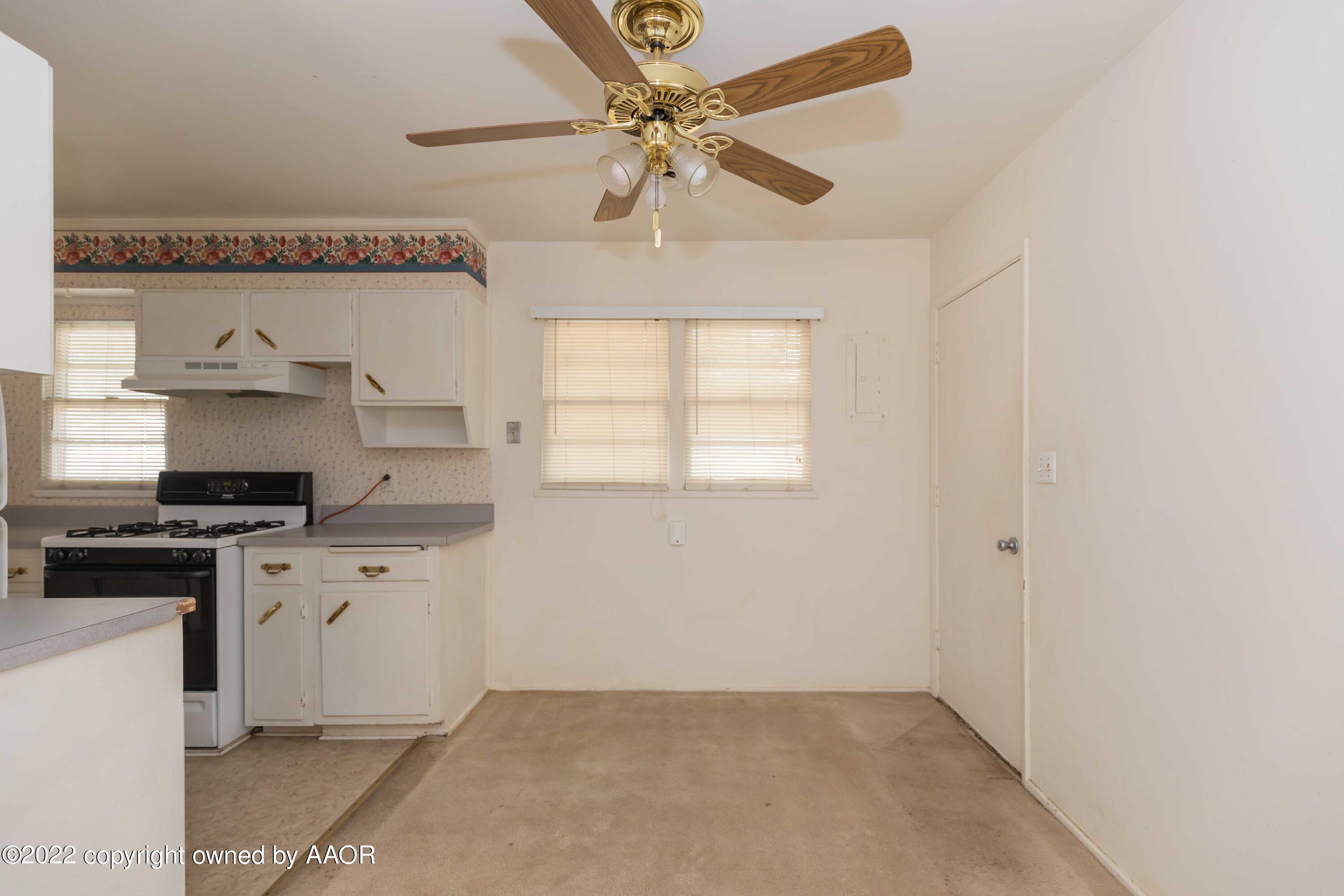 5138 Crockett Street Amarillo, TX 79110 - Photo 13 of 35 a kitchen with stainless steel appliances a stove a sink and a refrigerator
