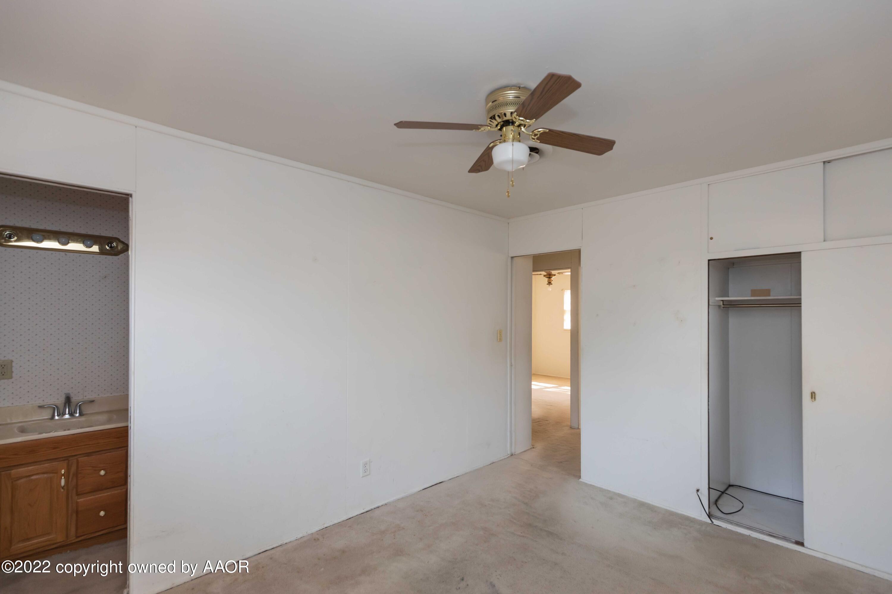 5138 Crockett Street Amarillo, TX 79110 - Photo 16 of 35 a view of a room with a ceiling fan and closet area