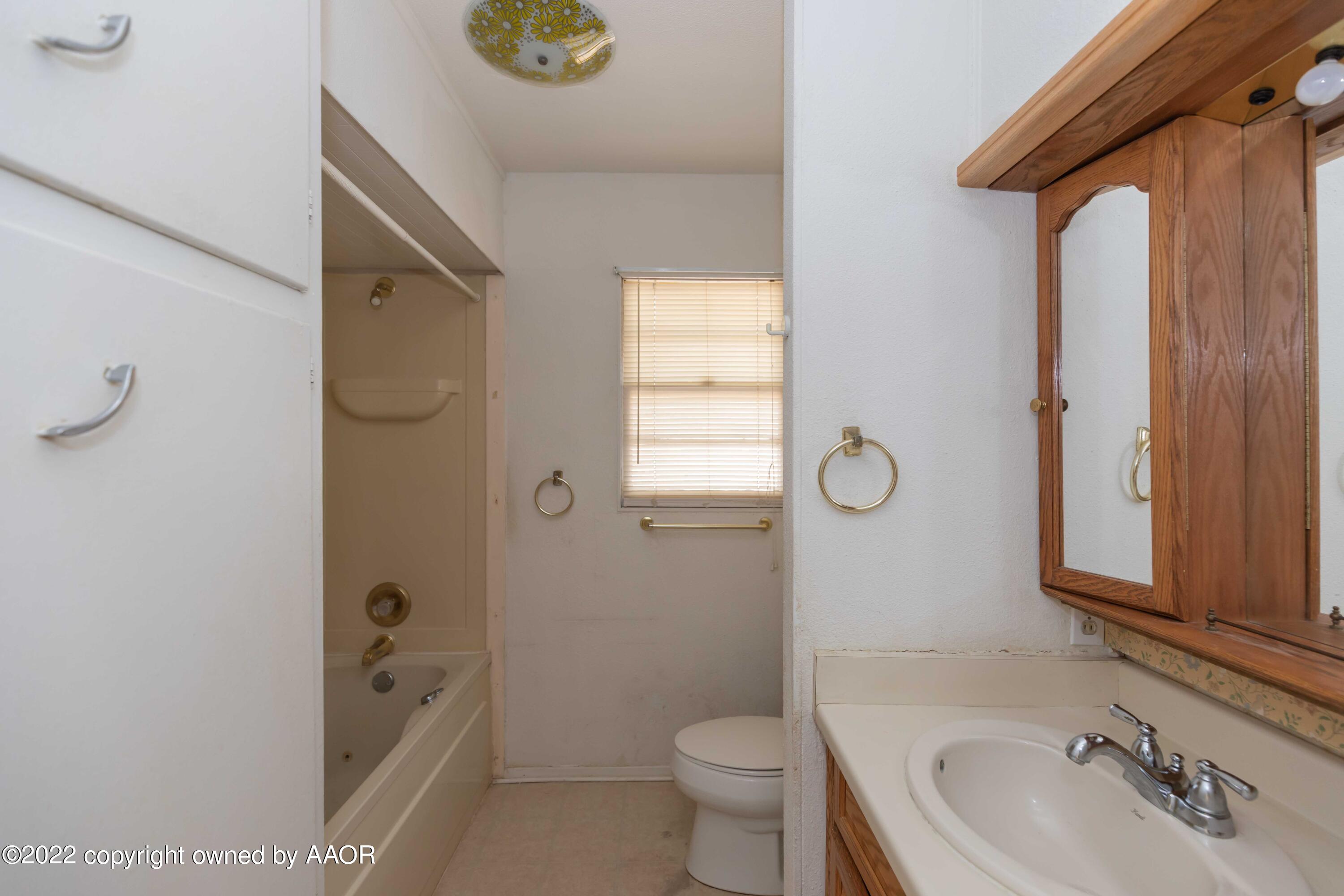 5138 Crockett Street Amarillo, TX 79110 - Photo 23 of 35 a bathroom with a sink a toilet and shower