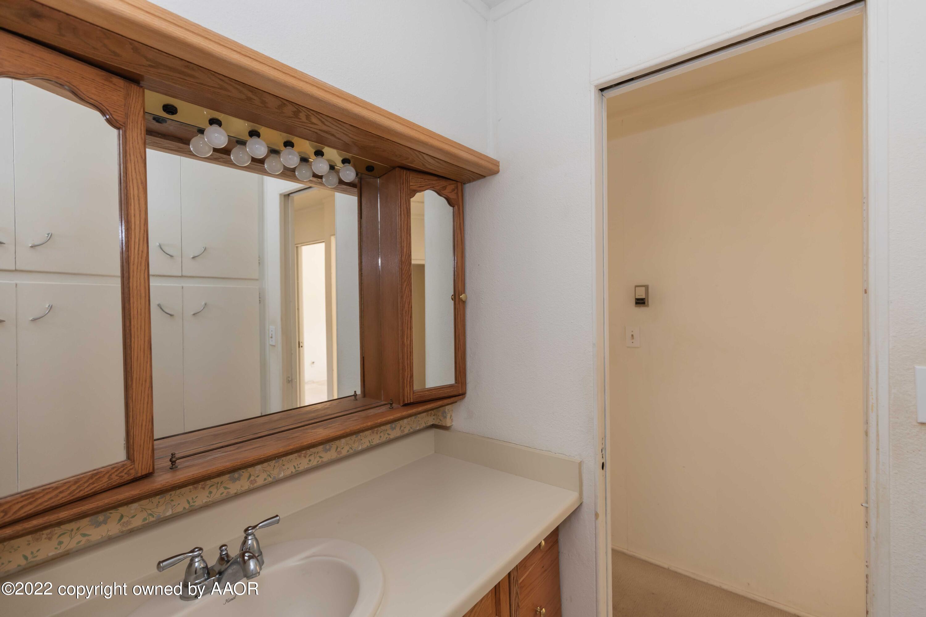 5138 Crockett Street Amarillo, TX 79110 - Photo 26 of 35 a bathroom with a sink and a mirror
