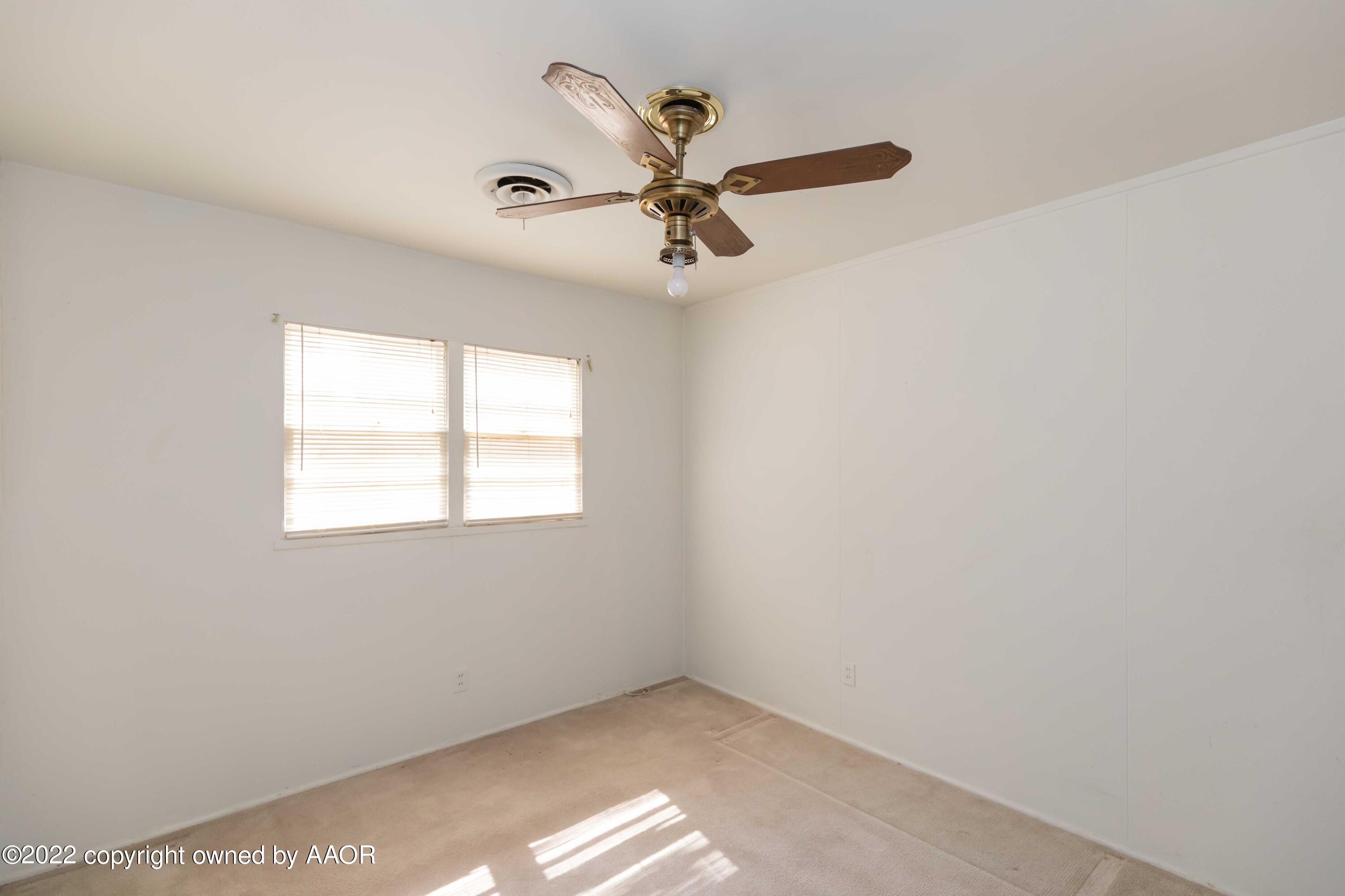 5138 Crockett Street Amarillo, TX 79110 - Photo 30 of 35 an empty room with a window and a fan