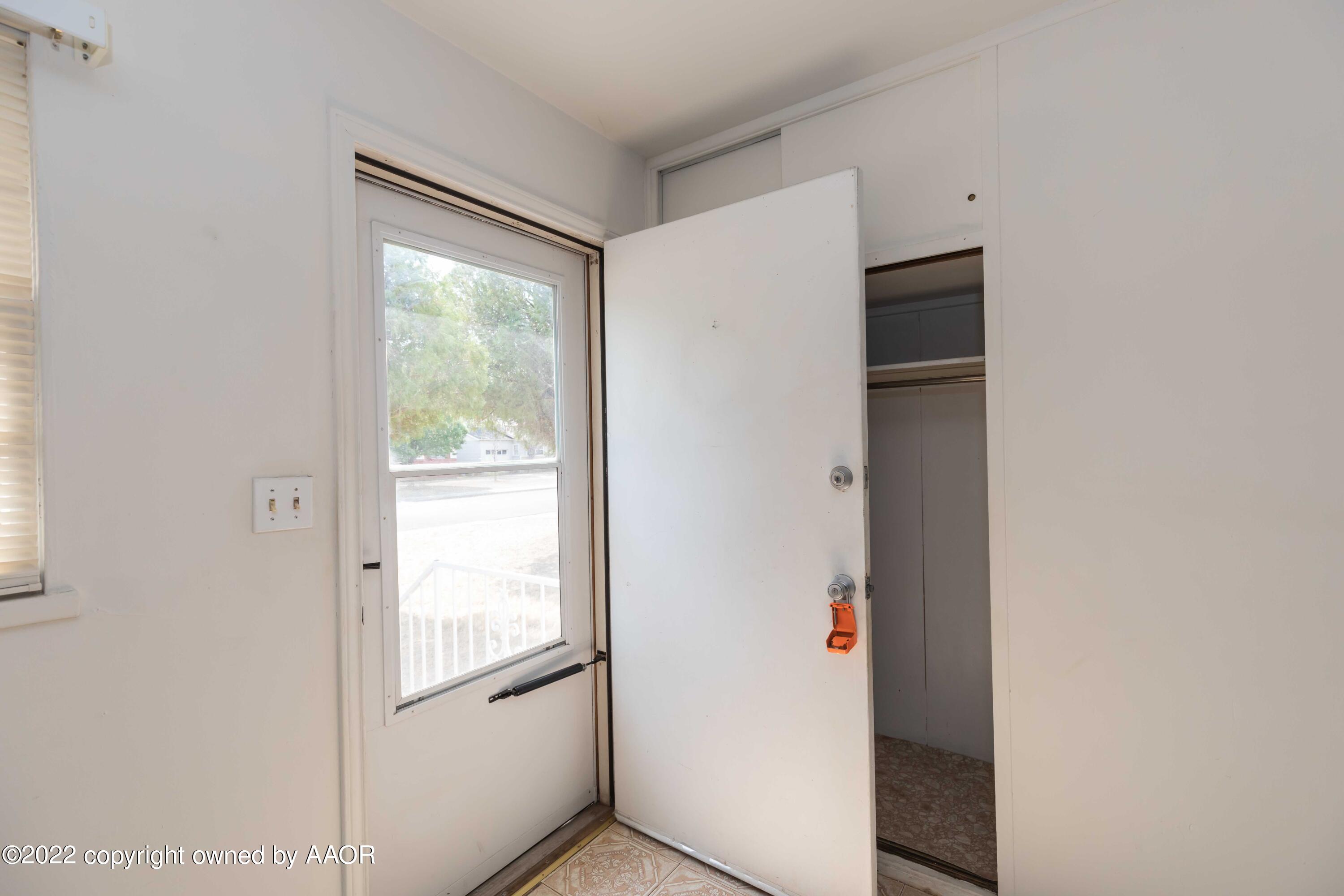 5138 Crockett Street Amarillo, TX 79110 - Photo 3 of 35 a view of an empty room with wooden floor and a window
