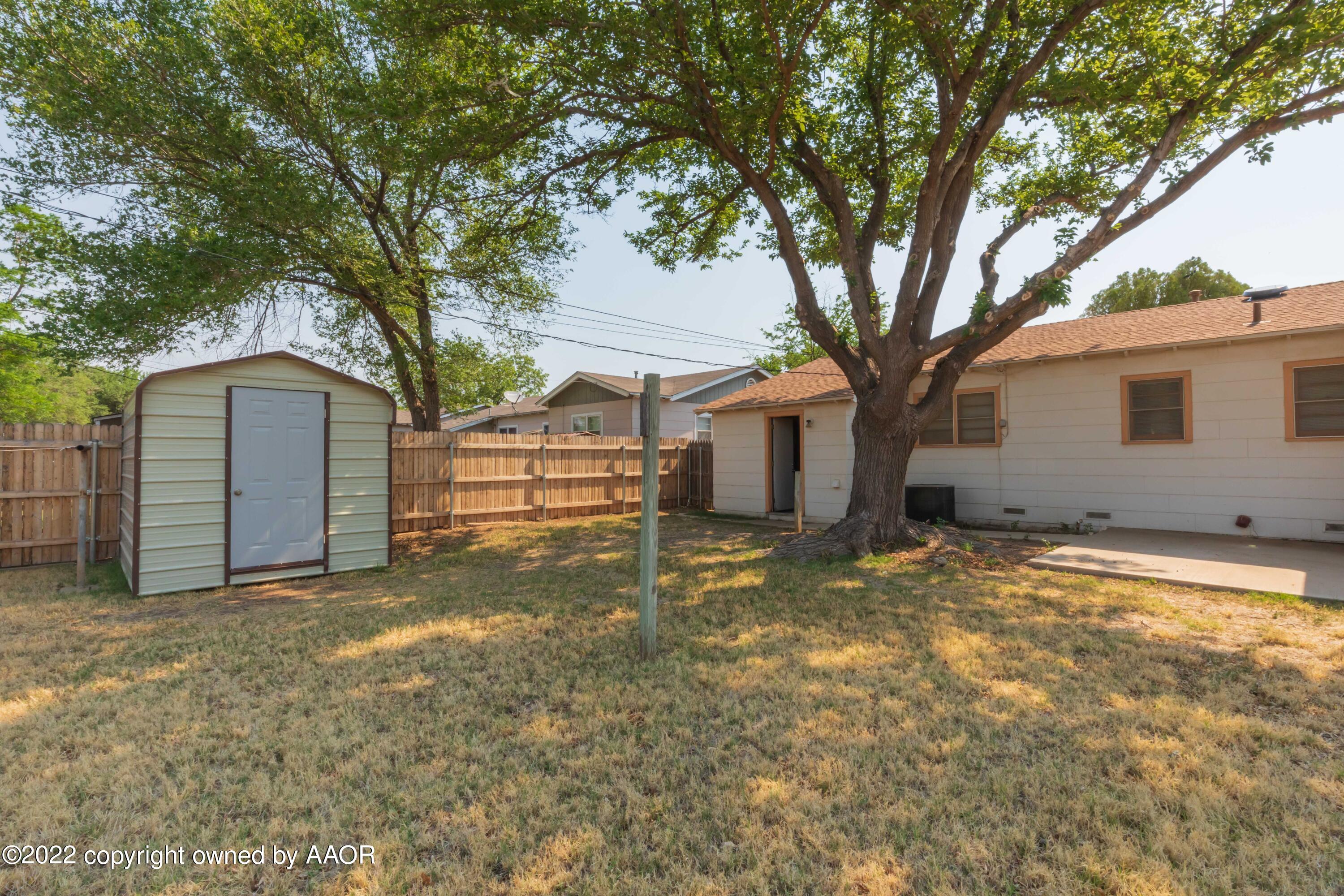 5138 Crockett Street Amarillo, TX 79110 - Photo 33 of 35 a view of a house with a yard and large tree