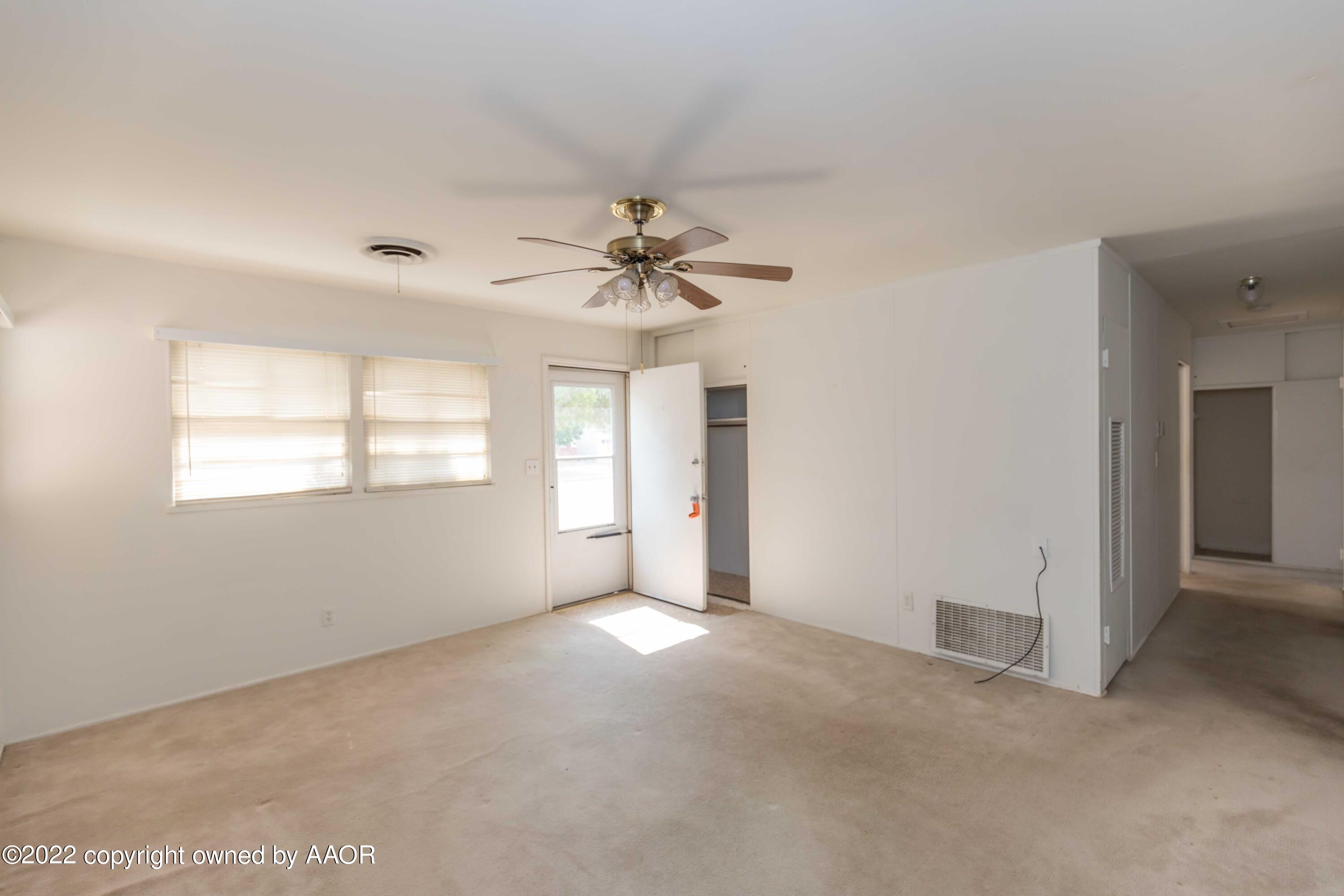 5138 Crockett Street Amarillo, TX 79110 - Photo 5 of 35 wooden floor in an empty room with a window