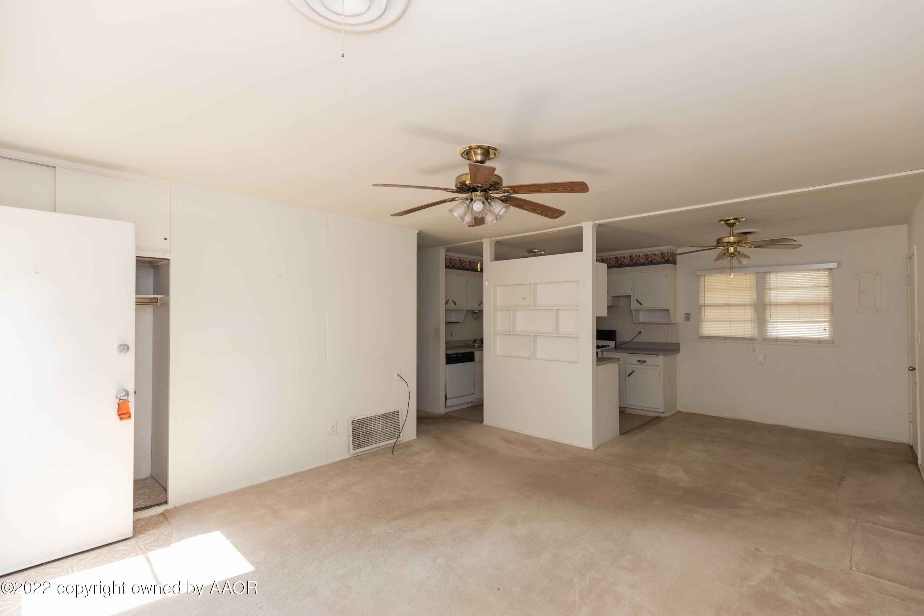 5138 Crockett Street Amarillo, TX 79110 - Photo 6 of 35 a view of a storage & utility room with a refrigerator