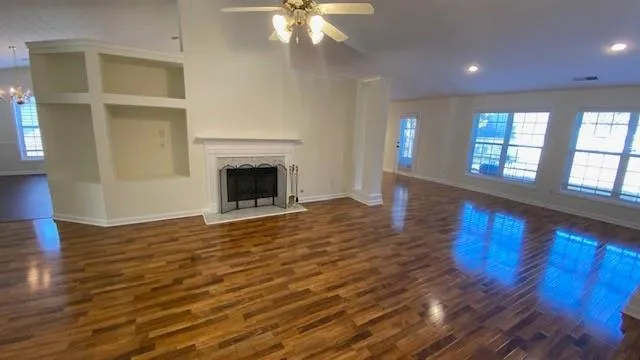 wooden floor fireplace and natural light in room