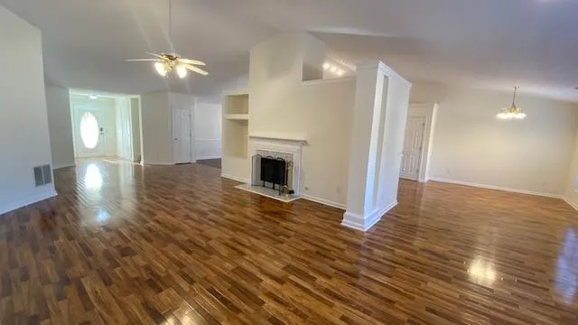 a view of a kitchen with wooden floor and a sink
